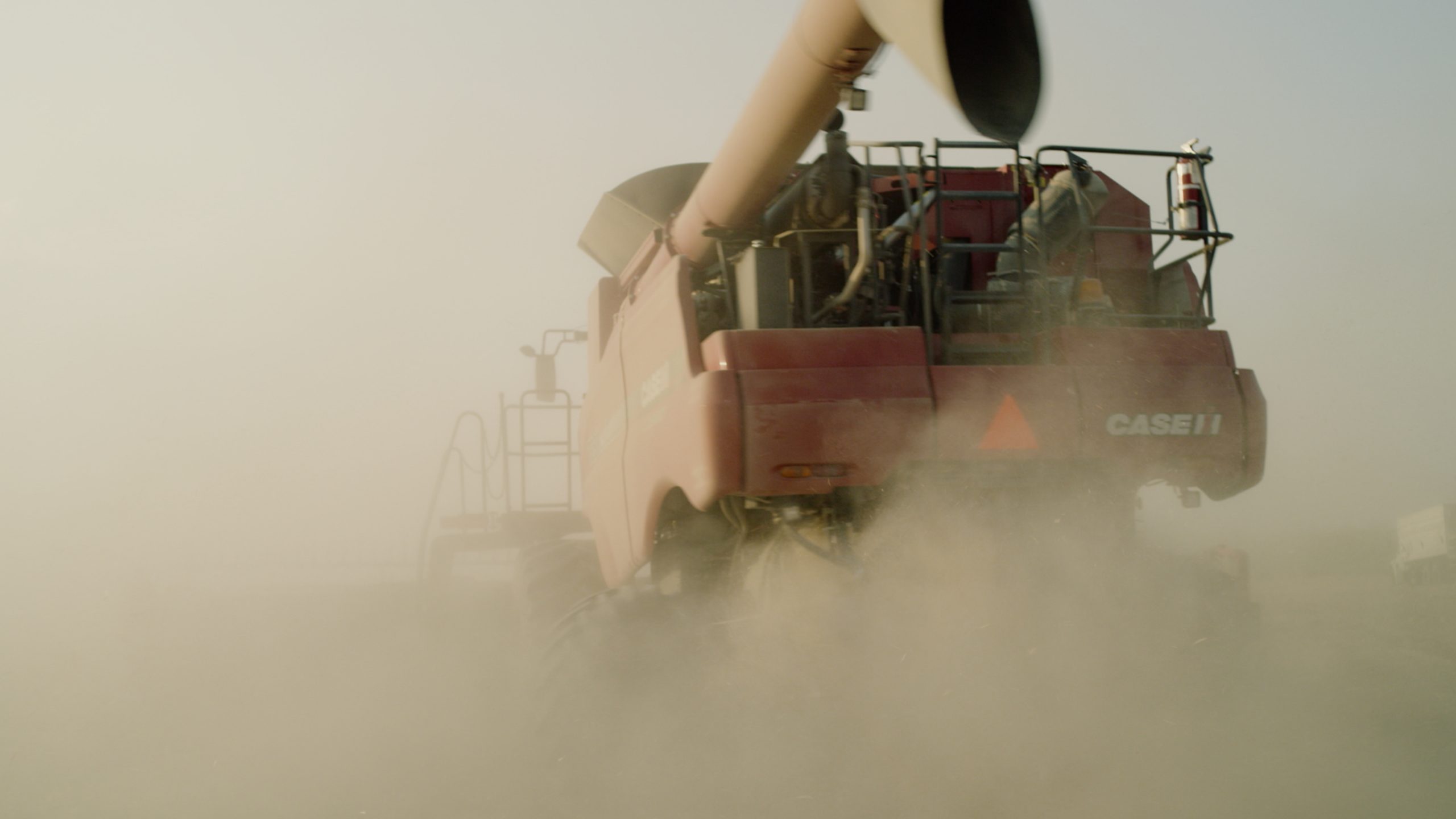 
Red Case combine harvester working in a dusty field – representing the high-demand agricultural machinery that Agriware's predictive maintenance solutions are designed to protect and optimise.