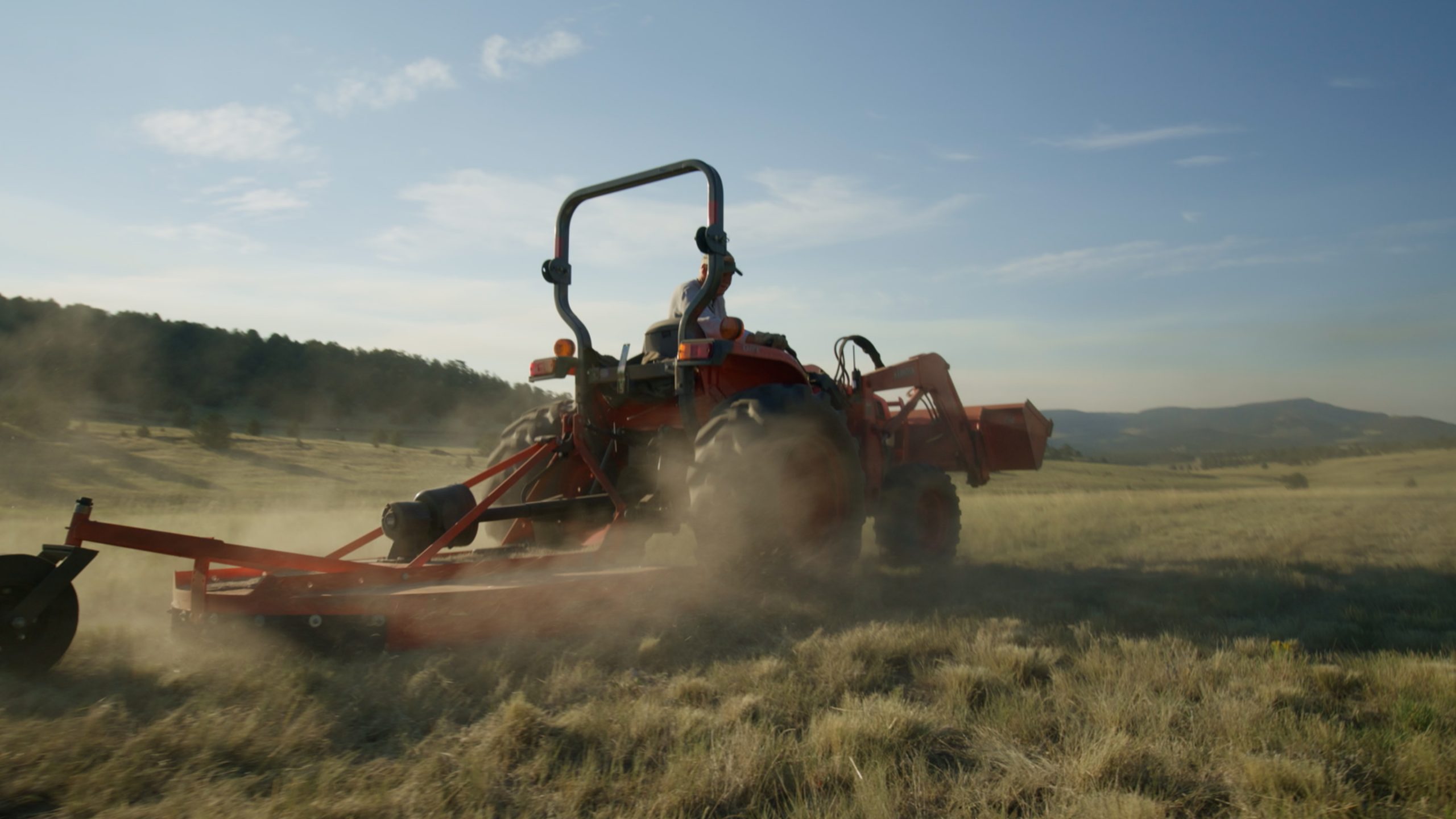 Kubota tractor working in an agricultural field – representing modern farm machinery that benefits from Agriware's predictive maintenance, real-time monitoring, and risk reduction solutions through Ops and Sentinel technology.